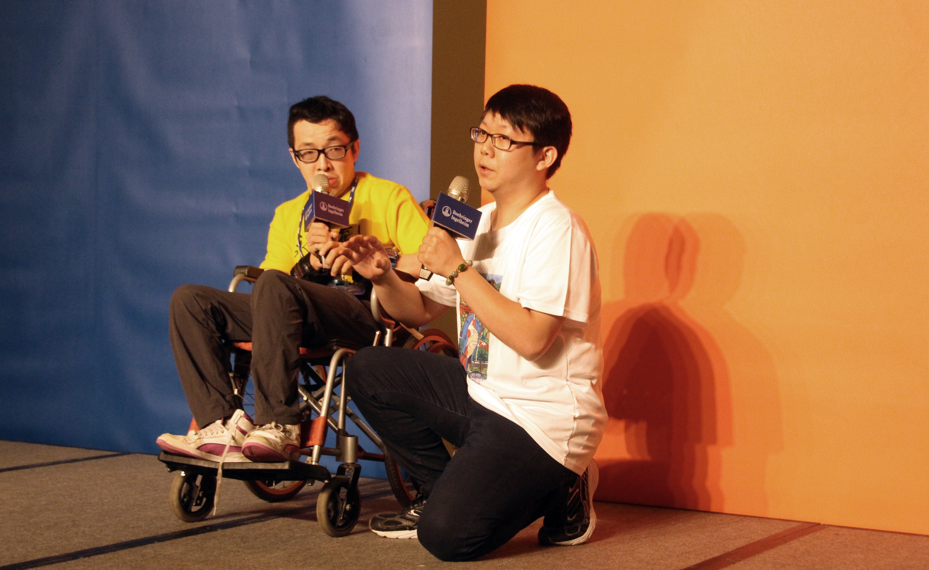 Disability Artist Duan-Zheng (left) happily sharing his thoughts on the event and his experience creating art